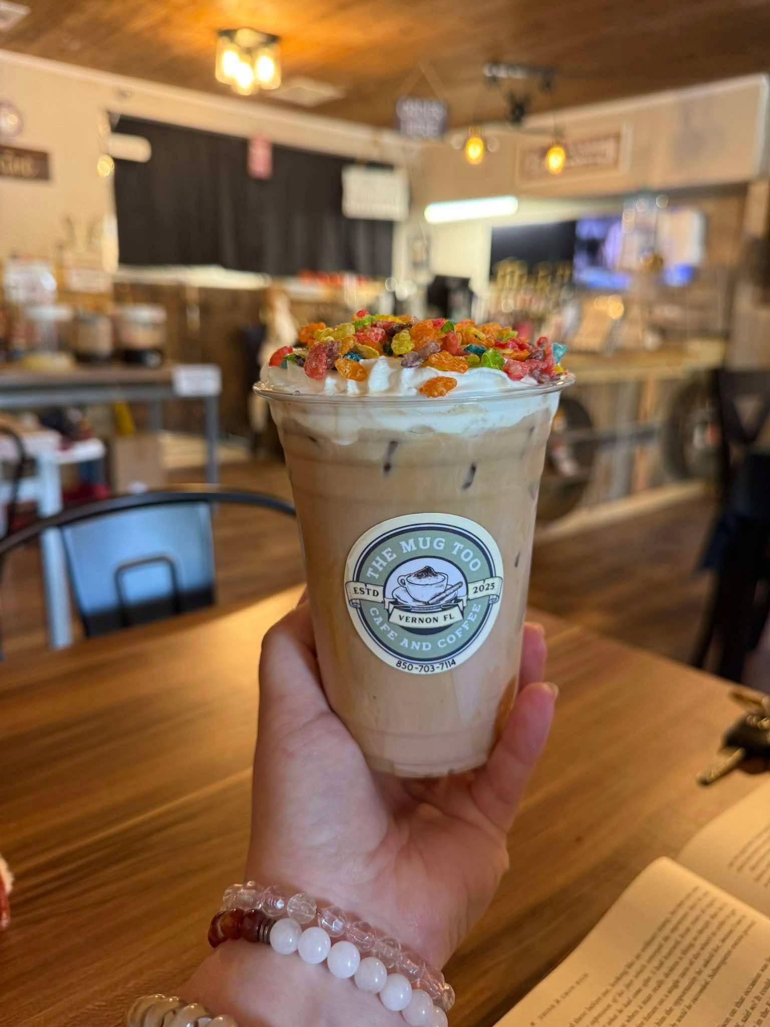 Iced latte topped with whipped cream and Fruity Pebbles cereal