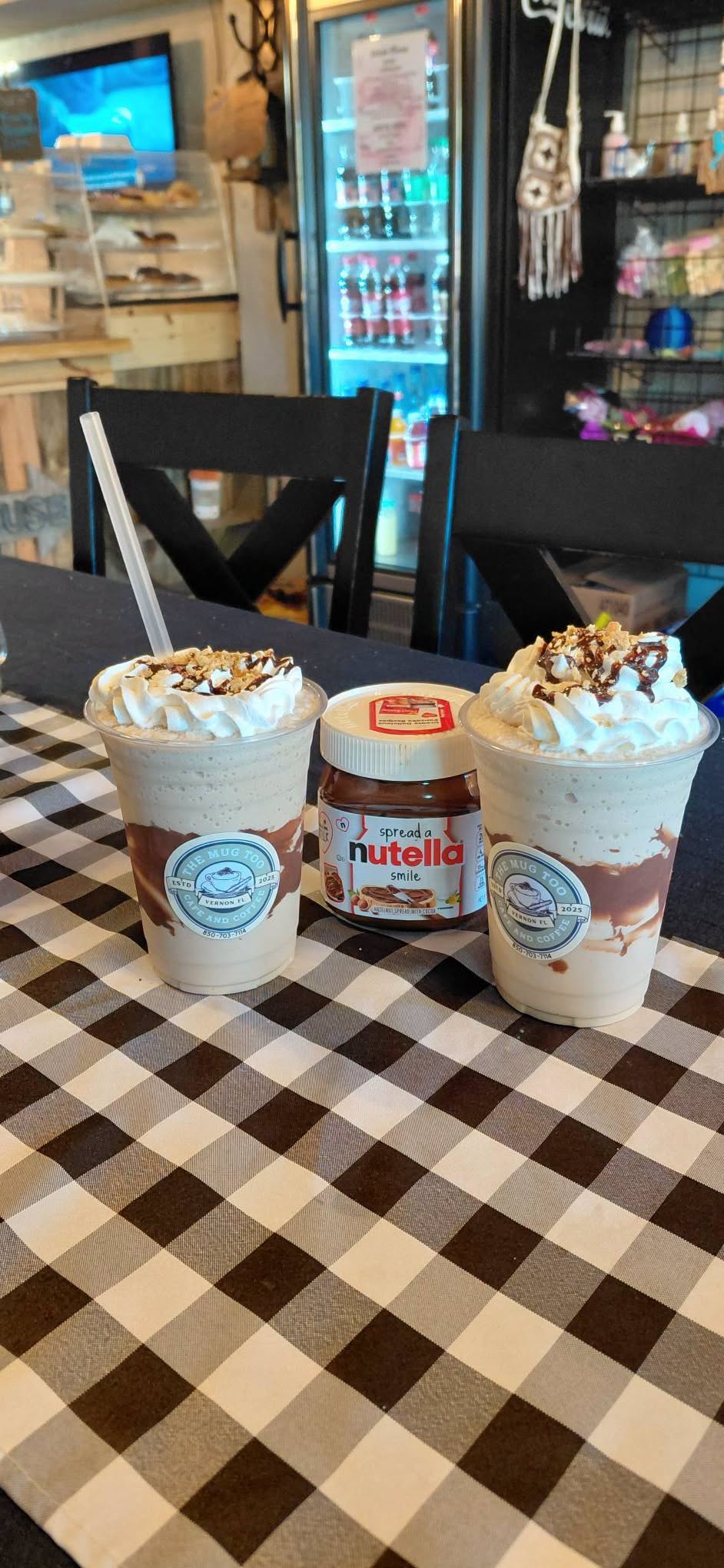 Frozen mocha drink blended with Nutella, topped with whipped cream and chocolate drizzle