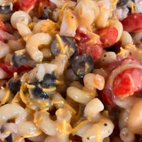 Pasta salad with tomatoes, cheese and olives